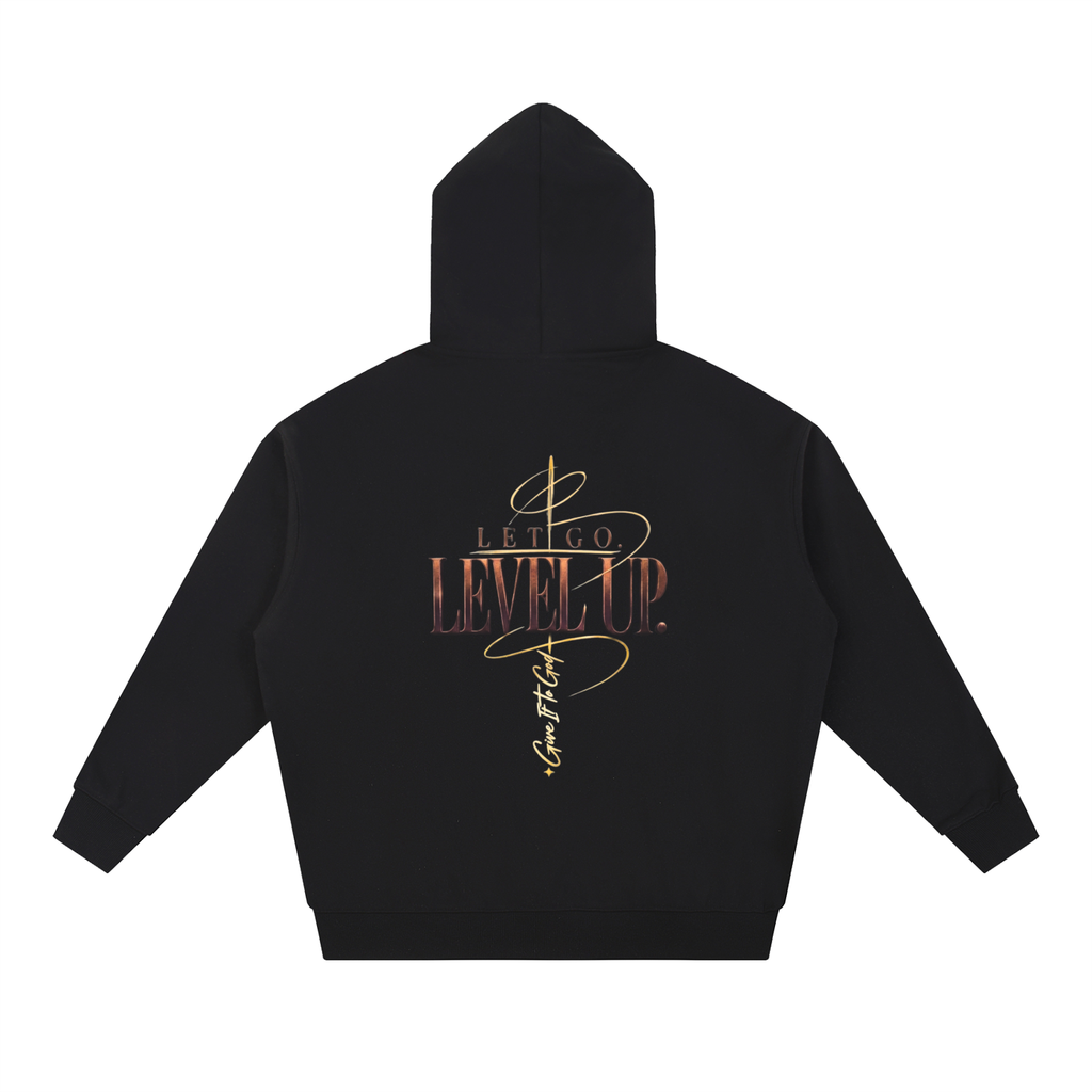 Give It To God black oversized hoodie featuring a metallic gold Let Go. Level Up. graphic on the back.
