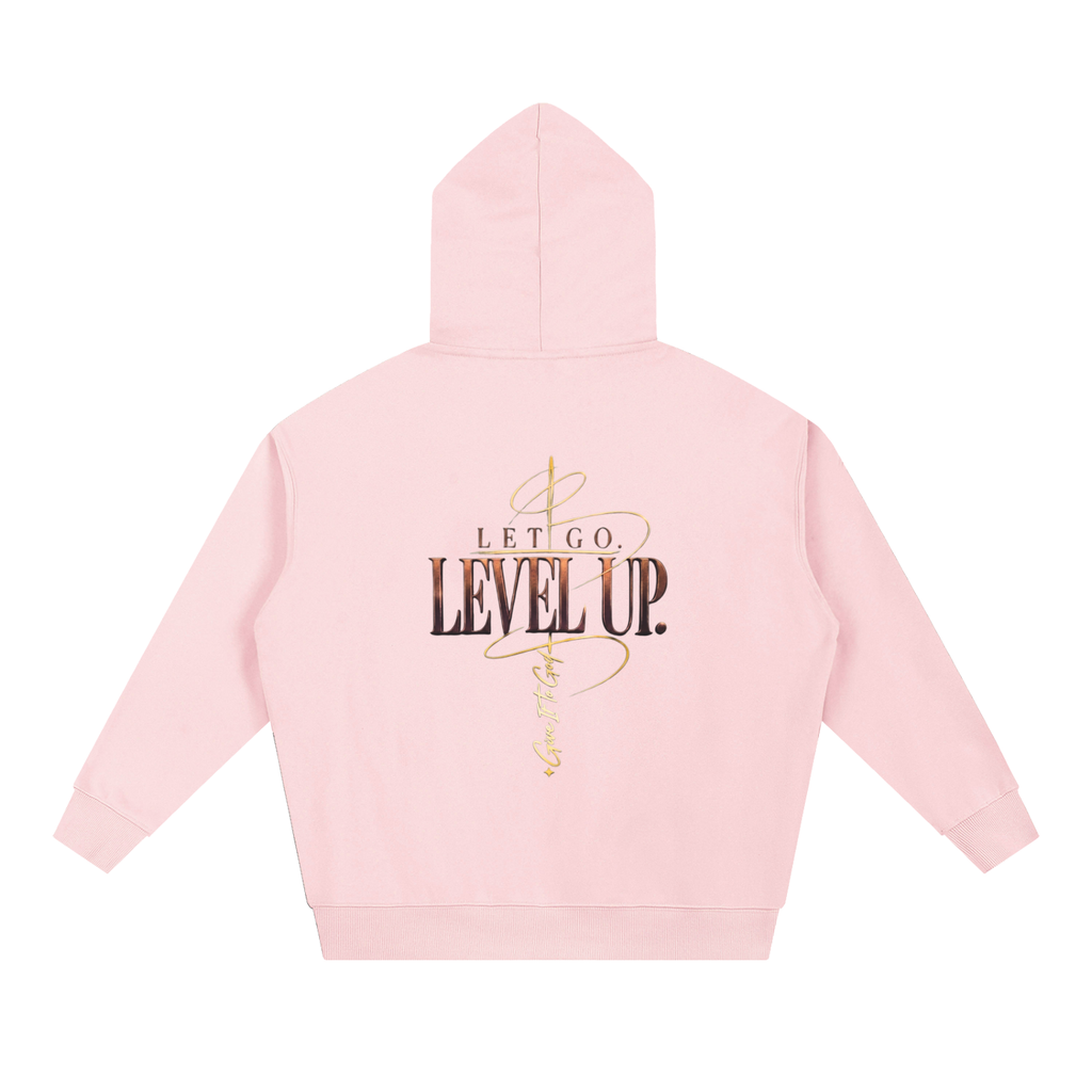 Give It To God oversized pink hoodie with metallic gold Let Go. Level Up. graphic on the back, drop-shoulder fit.